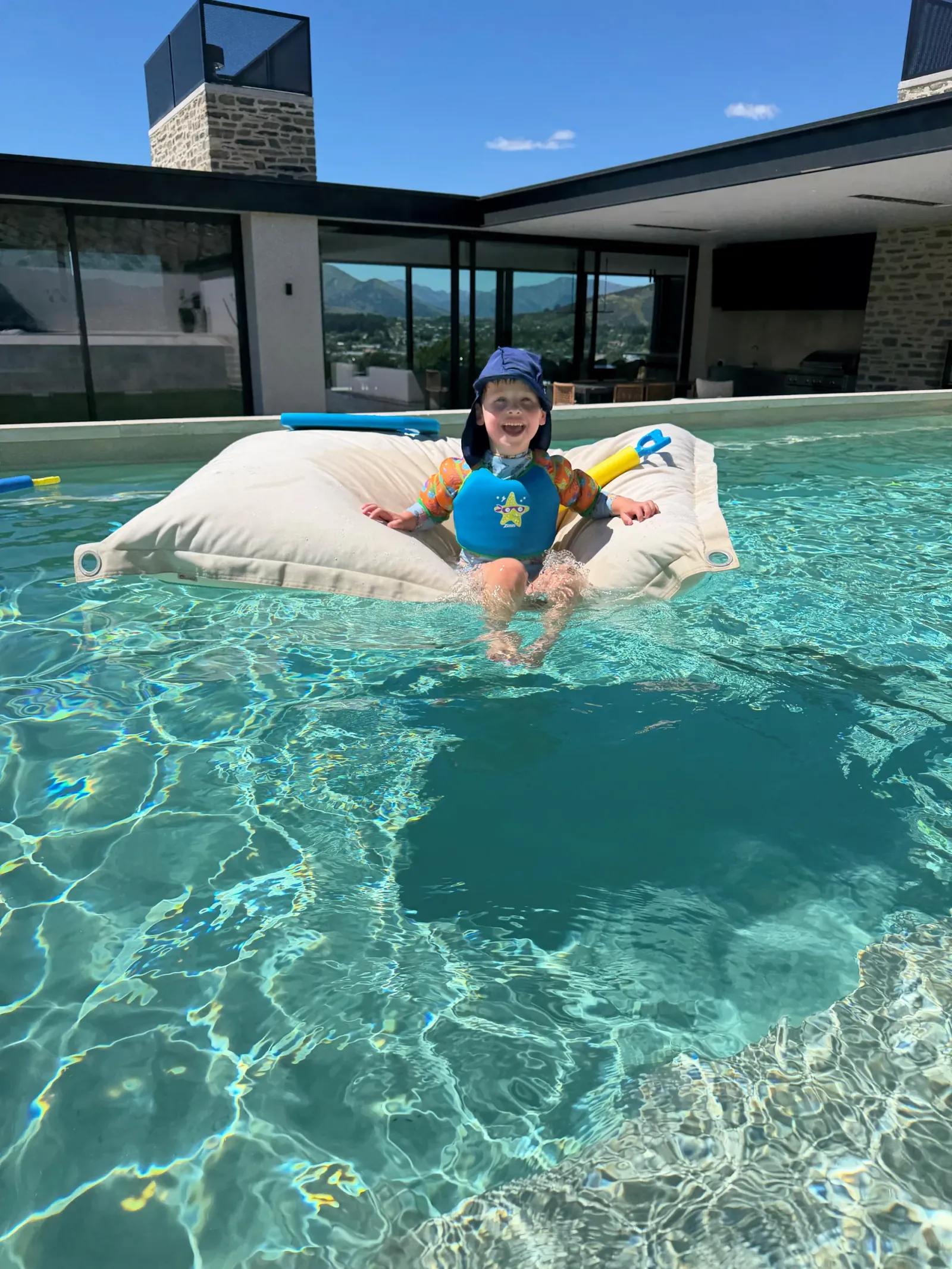 A child floating in the Duponts' own pool