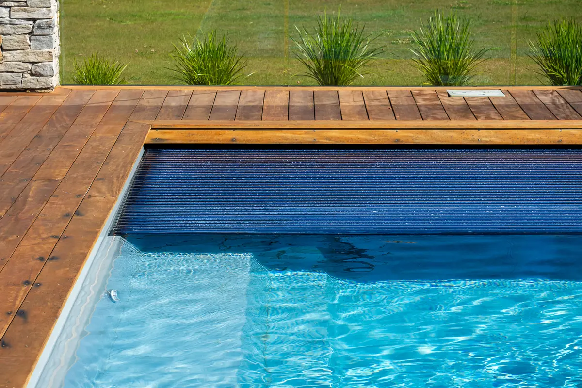A slatted automatic cover part closed over a pool