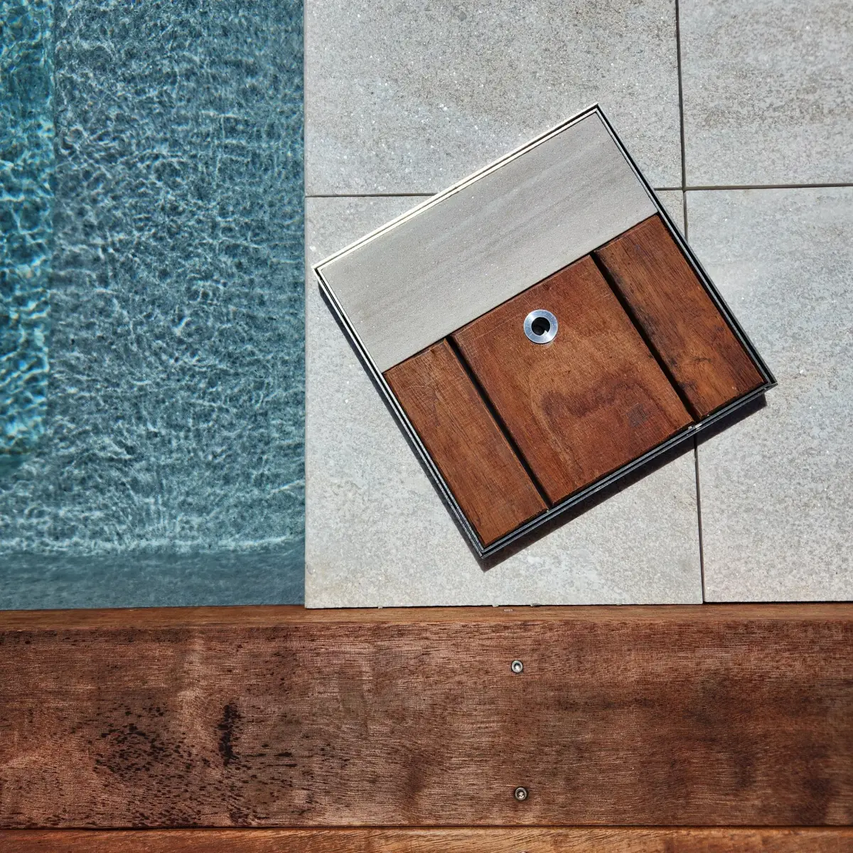A concealed skimmer lid finished in timber to match the deck