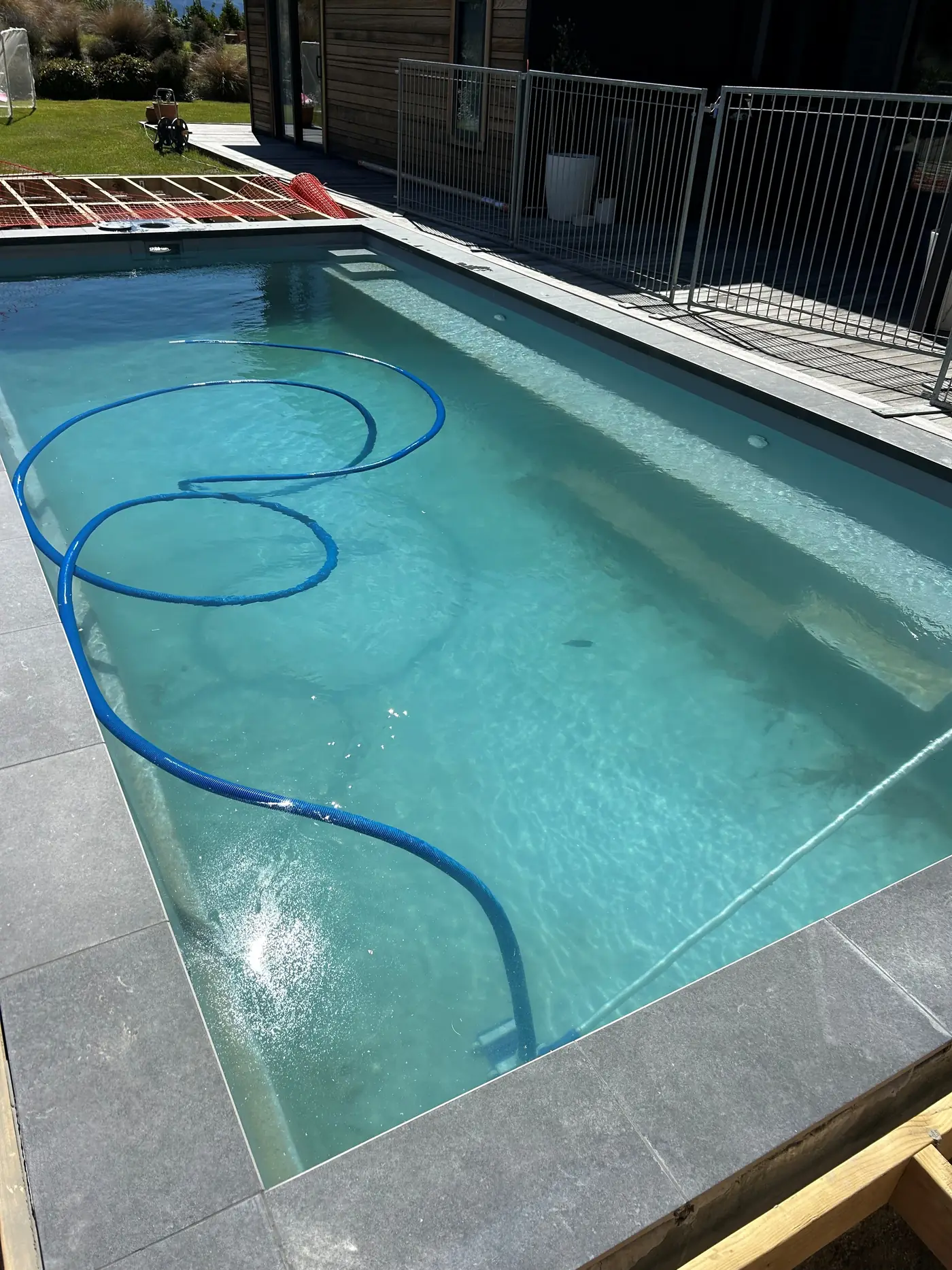 A pool being cleaned before handover