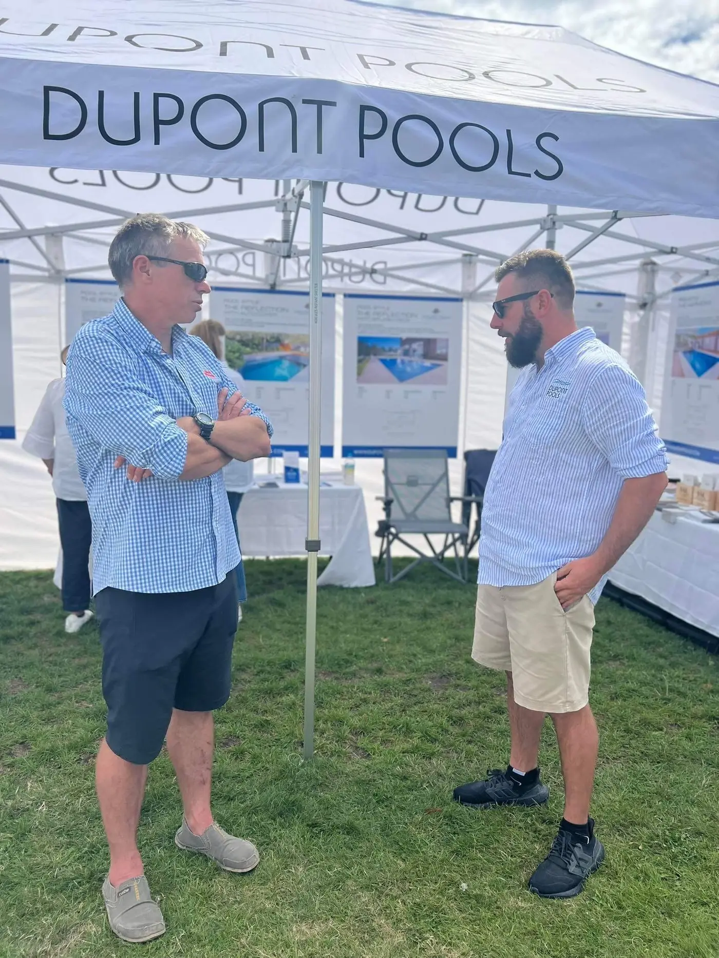 Tom talking with a client under the Dupont Pools tent